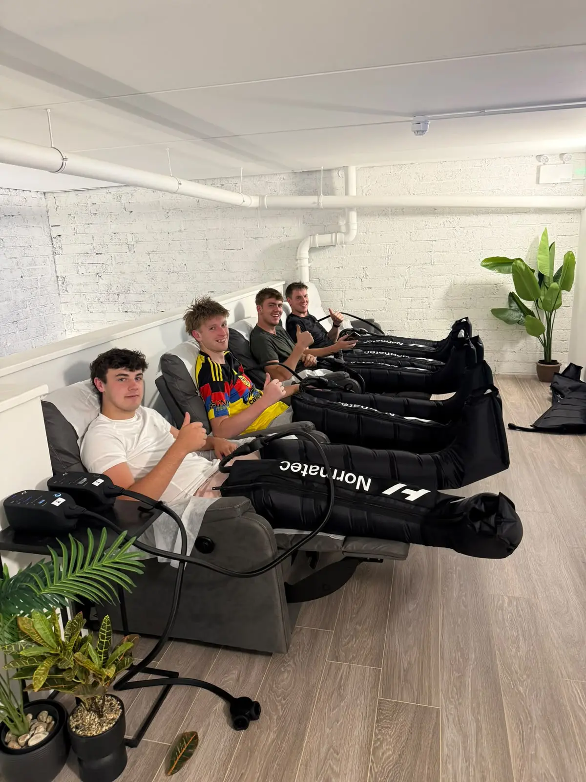 Guests in the recliners with the boots on, seen along the row towards the plants